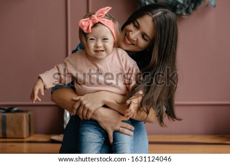 Mother's love and care. Down Syndrome daughter. The concept of love for children. 
Mom spends free time with her daughter. Royalty-Free Stock Photo #1631124046