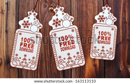 free 3d rendered christmas labels with 100 percent free download sticker in front of a nice wooden background