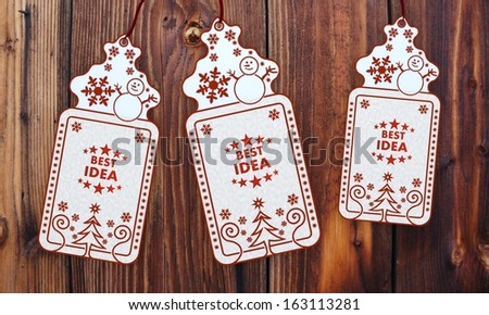 friendly 3d rendered christmas labels with best idea sign in front of a nice wooden background