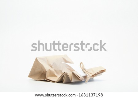 Gift paper parchment bag with bow and note. On white background