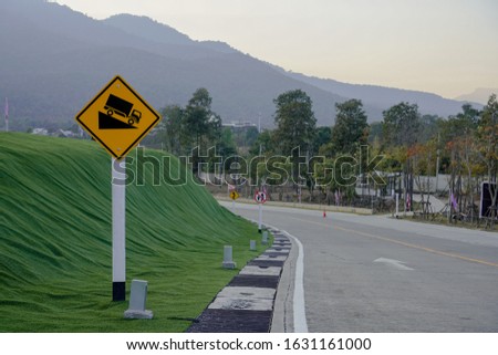 Yellow steep slope warning sign
