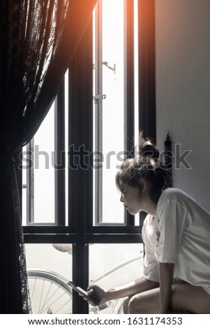 Woman Sitting At Home Using Mobile Phone, Sad emotion