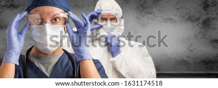 Female and Male Doctors or Nurses Wearing Scrubs and Protective Mask and Goggles Banner. Royalty-Free Stock Photo #1631174518