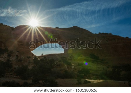 Arch with a sunburst in the desert