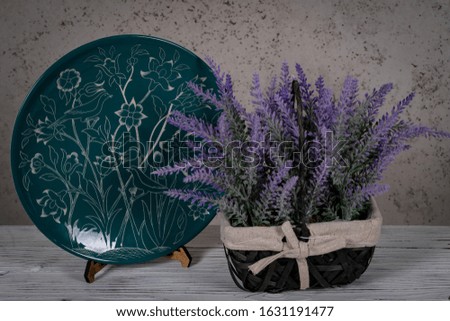 Decorative, painted plate on a gray background.
