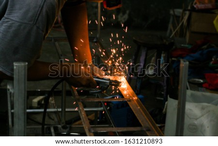 Dark yellow sparks electric welding blur