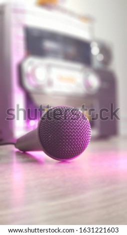 Microphone in focus with blurred boom box in the background