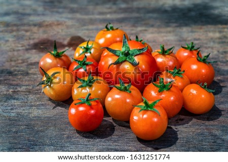 Fresh tomatoes on wood background, high quality, beautiful red ripe heirloom tomatoes grown in a greenhouse, Da Lat, Vietnam