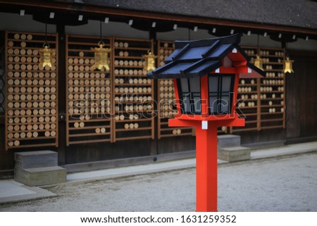 Japanese style garden lamp in a temple. Japanese gable roof house light post lantern in traditional garden.
