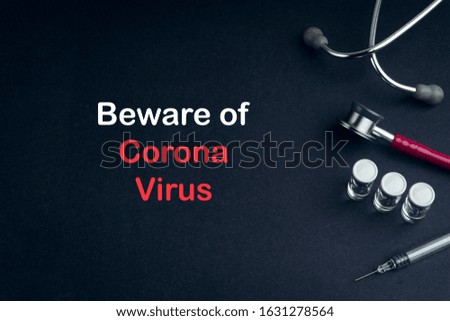 Stethoscope, Vial, and Syringe with words BEWARE OF CORONAVIRUS on black background. Covid-19 concept and coronavirus