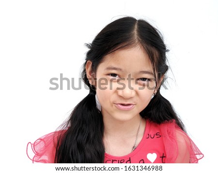A cute white Asian girl with long black hair wearing a red shirt is smiling happily with white background.
