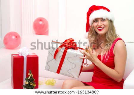 Christmas Santa hat woman portrait hold christmas gift. Smiling happy girl on white background.
