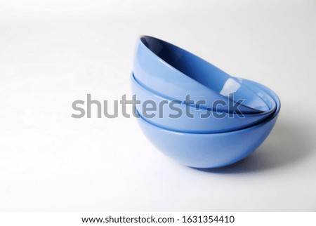 stack of bright blue dishes close-up isolated on a white background
