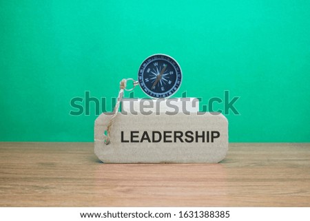 Magnetic compass and text LEADERSHIP written on paper, Leadership and creative concept