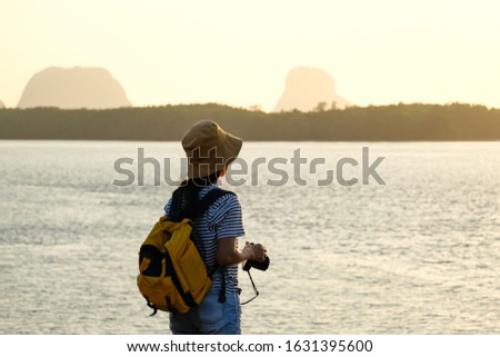A female asian sightseeing beautiful sea and mountain in early morning
