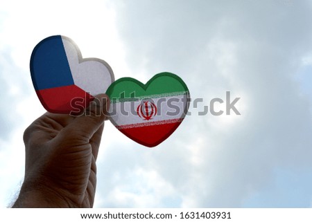 Hand holds a heart Shape Czech Republic and Iran flag, love between two countries