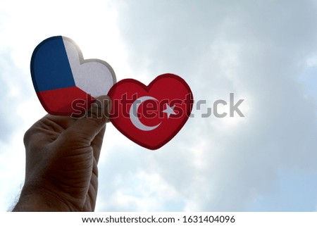 Hand holds a heart Shape Czech Republic and Turkey flag, love between two countries