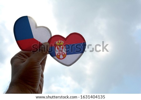 Hand holds a heart Shape Czech Republic and Serbia flag, love between two countries
