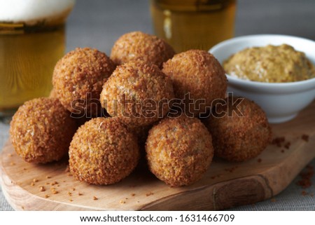 Bitterballen are a Dutch meat-based snack, made by making a very thick stew thickened with roux and beef stock and generously loaded with meat. Royalty-Free Stock Photo #1631466709