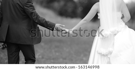Hands of wedding couple. Picture in black and white. Togetherness.