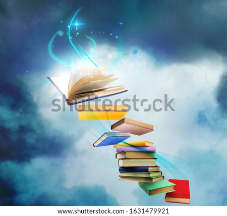 Flying books with fairytales and magic lights on blue background. Creative design