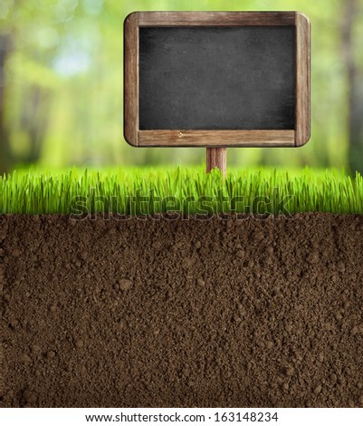 soil in garden with blackboard sign