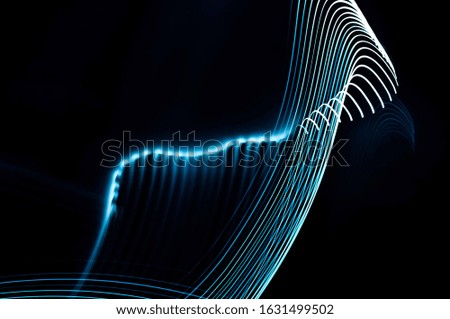 
blue streaks of light, and glare in the dark on a black background 