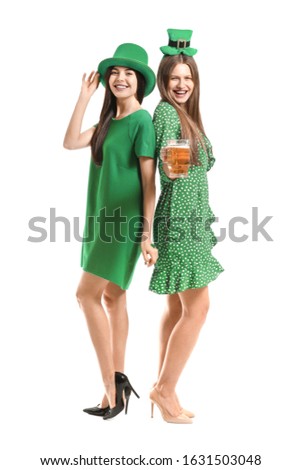 Young women with beer on white background. St. Patrick's Day celebration
