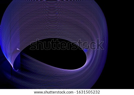 
Multi-colored light vortexes on a black background, lightnings on a black background, light lines, blue, purple light brushes, freezelight