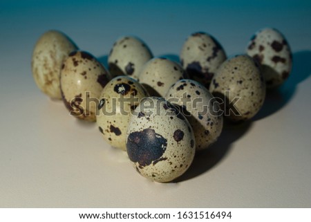 triangle quail eggs for billiards, bowling, blue background, close-up, copy space