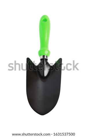Garden scoop with a green handle for planting plants. Close-up. Top view. Isolated on white.