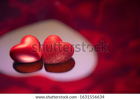 Two red hearts against holiday defocused  background. Valentines day concept.