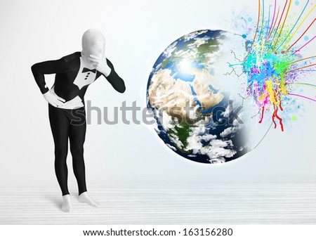 Funny man in body suit looking at colorful splatter 3d earth