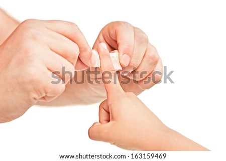 Dad putting a plaster on his sons finger isolated on white background