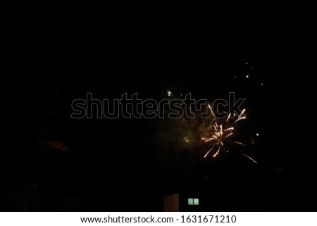 firework in blurred focus. black background. 