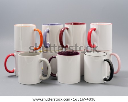 colored cups for sublimation in composition on a gray background