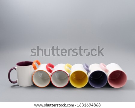 colored cups for sublimation in composition on a gray background
