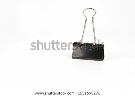 Large clip, black paper, isolated on a white background