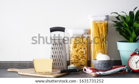 Kitchen utensils with products on the background of the kitchen, place fo text. Royalty-Free Stock Photo #1631731252