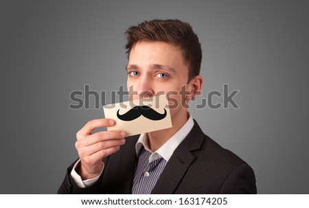 Happy businessman holding funny mustache card on his mouth with gradient background