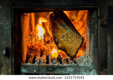 Closeup of the piece of wood burning in the oven