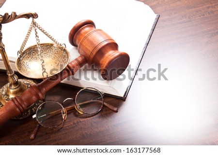 Gavel, glasses, book and scales on the table