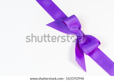 Purple ribbon and bow isolated on white