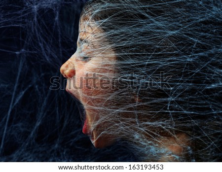 Scared girl trapped in a spider web Royalty-Free Stock Photo #163193453
