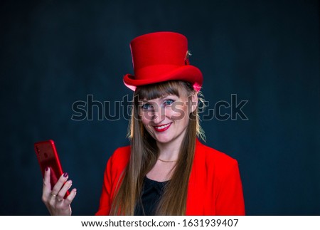 A girl in a red jacket and a red top hat 