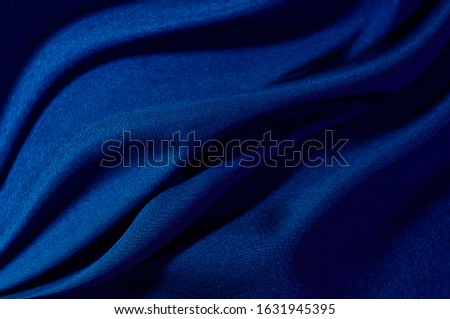 abstract fabric background. waves folds of fabric dark blue color trend 2020. design for any purpose