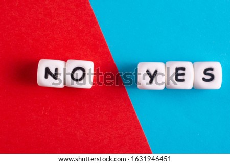 The words YES and NO made up of white plastic cubes. Choosing the right decision.