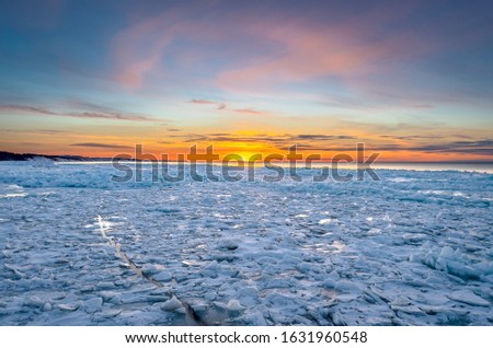 Winter sunset over Lake Superior near the Pictured Rocks National Lakeshore, Grand Marais Michigan.