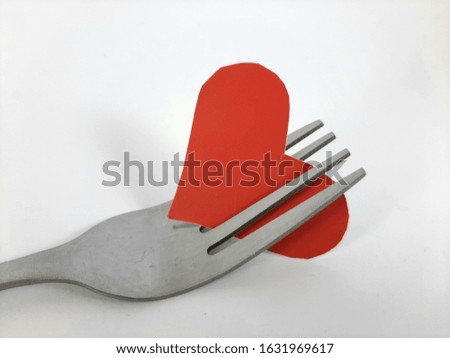 Red paper heart on cutlery