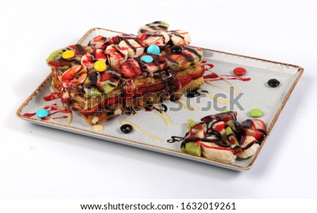 Belgium waffles with chocolate sauce, ice cream and strawberries isolated on white background